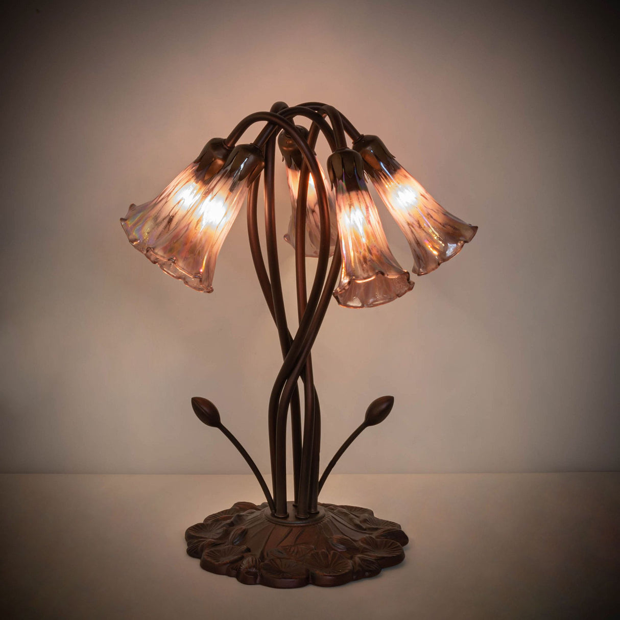 Illuminated view of purple Tiffany lamp in dim lighting.