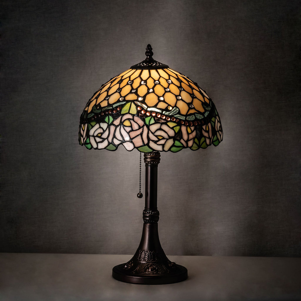 Ambient-lit view of jeweled rose table lamp highlighting soft glow.