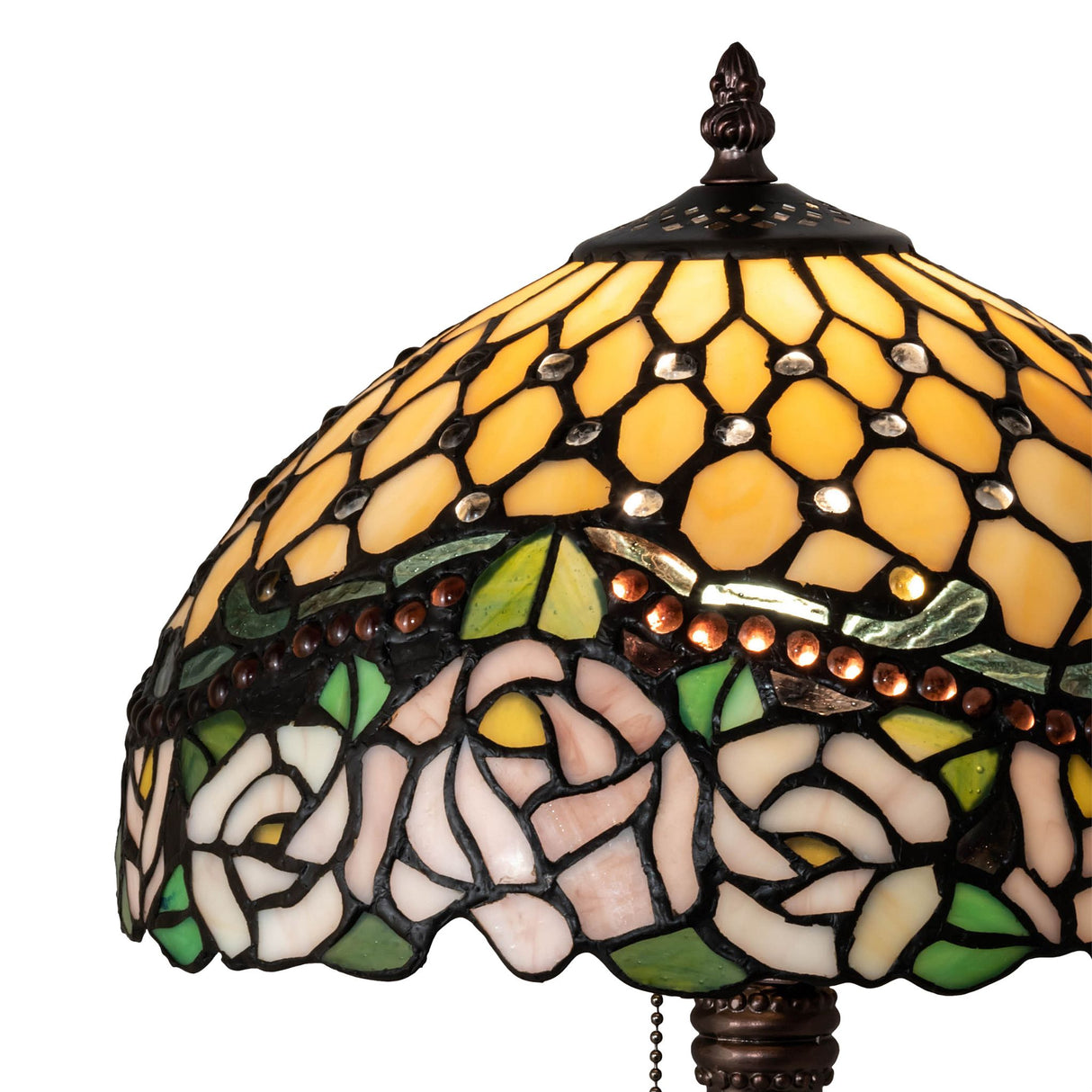 Detailed view of the lamp’s stained glass top with yellow and green hues.