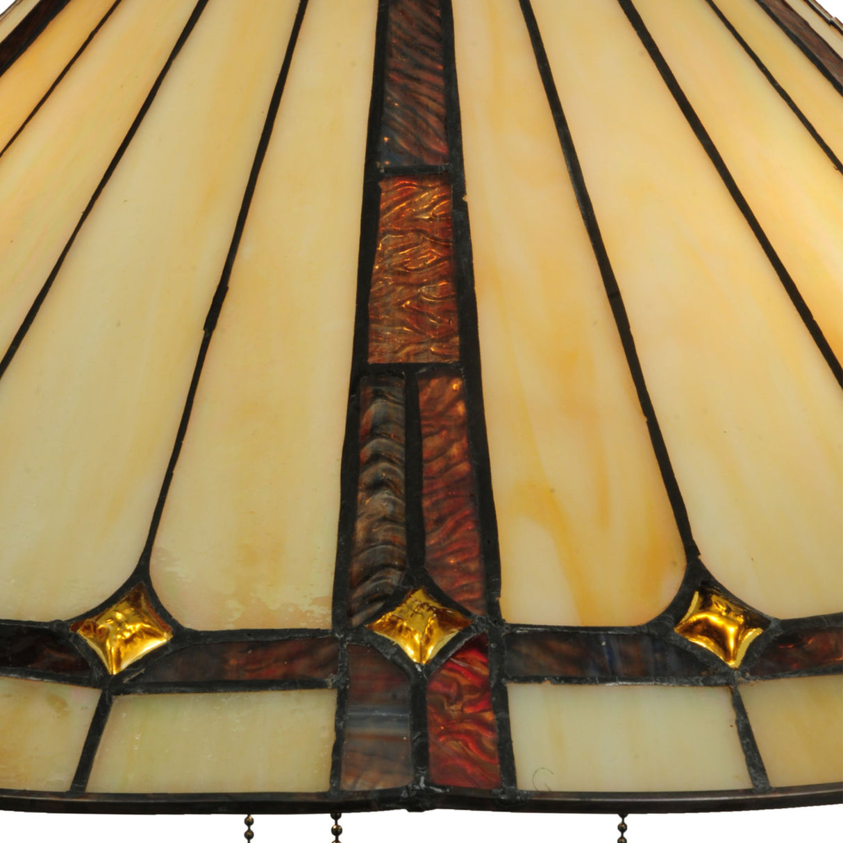 Close-up of amber, brown, and gold decorative accents on a stained glass pendant.