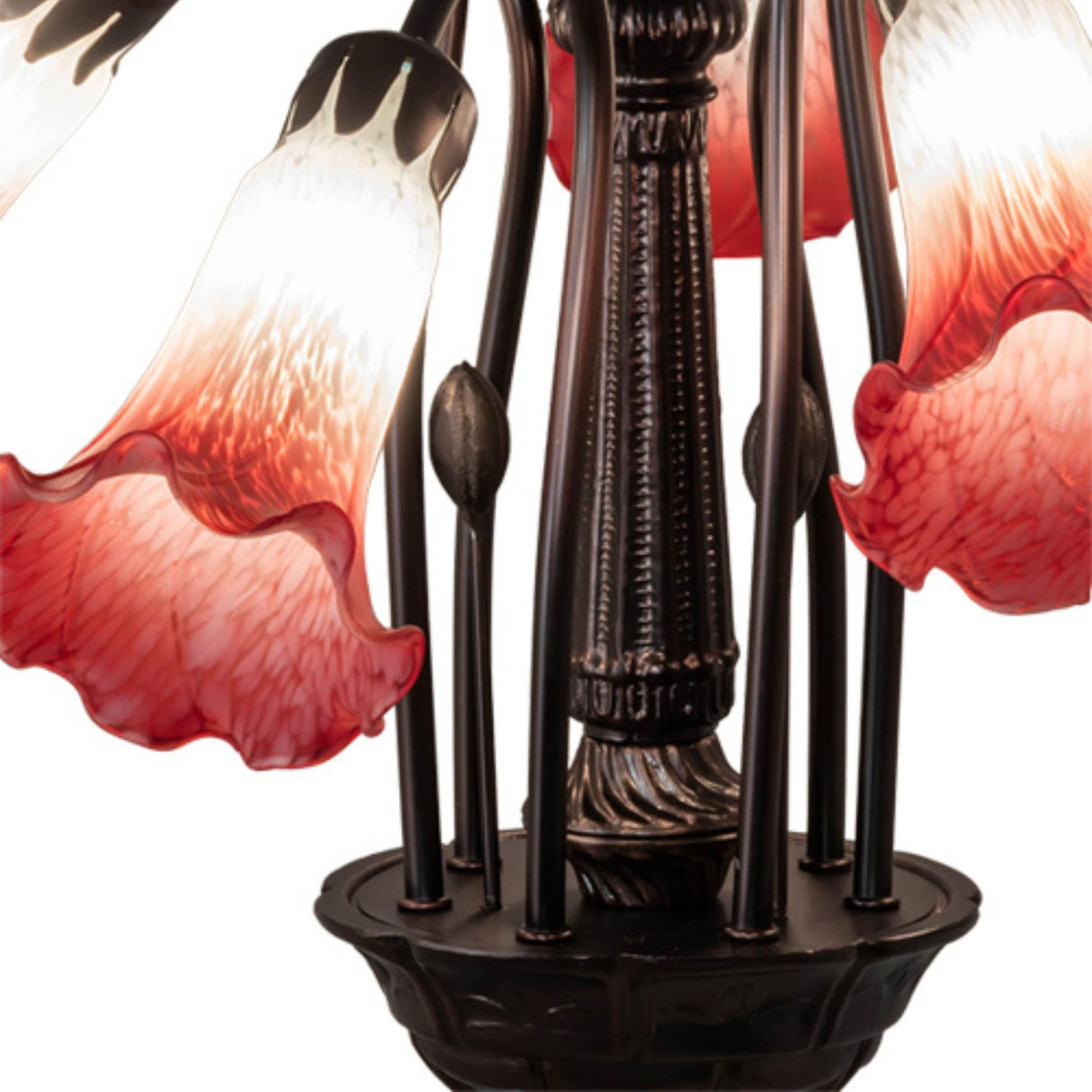 Close-up of bronze frame and vibrant red and white lily-shaped glass shades.