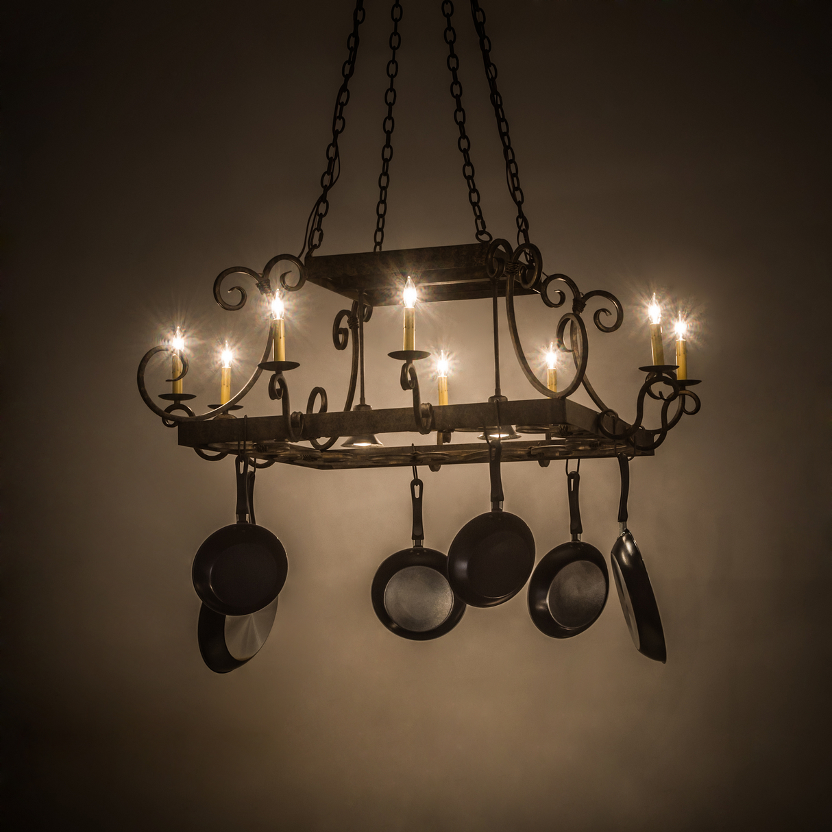 Caiden 10-light pot rack glowing warmly in kitchen setting.