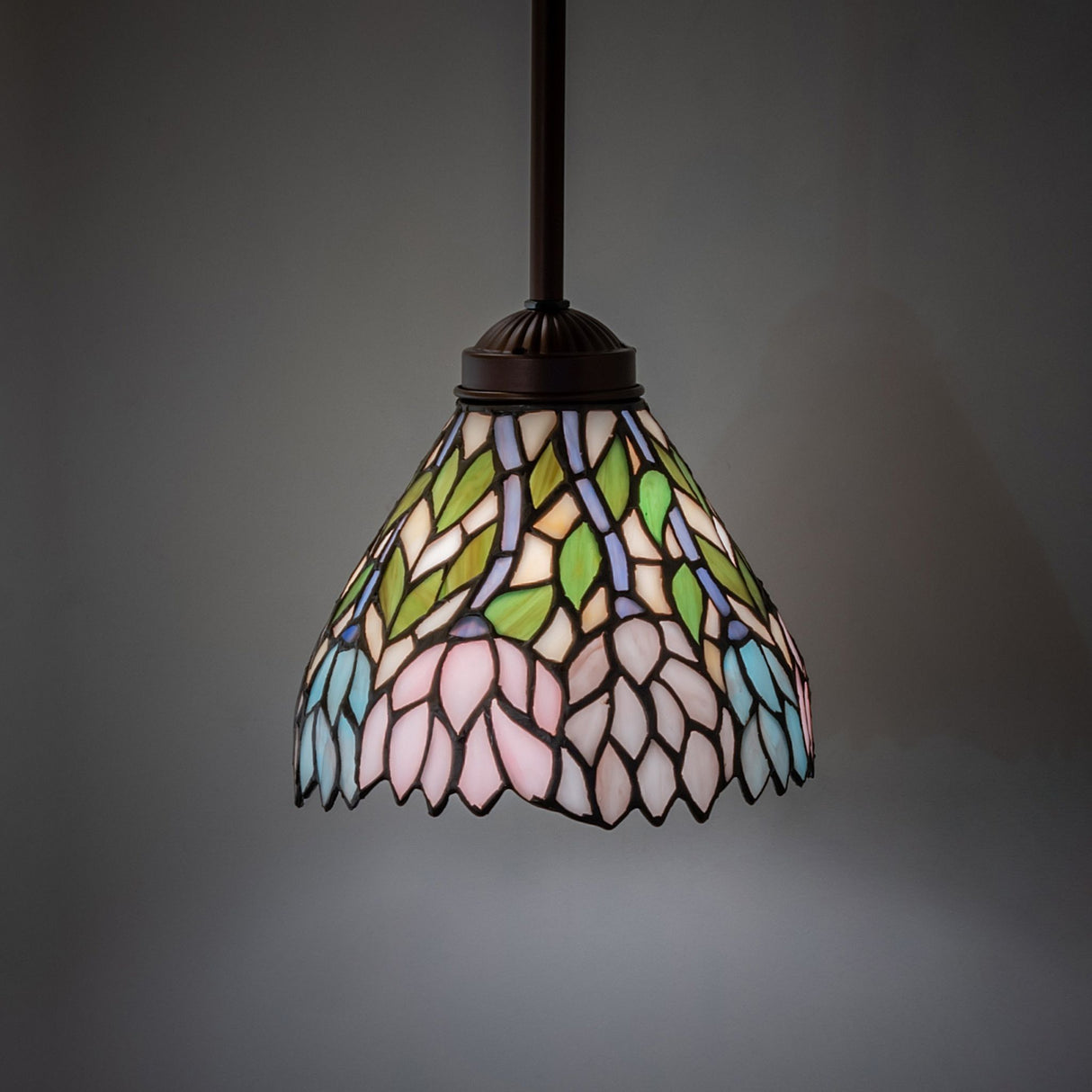 Illuminated Wisteria Mini Pendant showing vibrant stained glass details.