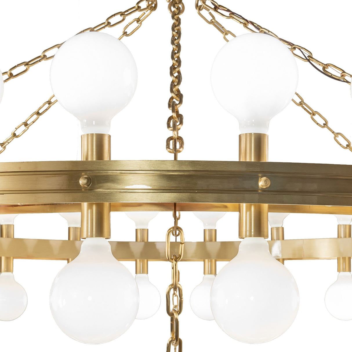 Albion chandelier close-up showing globe bulbs, brass ring rivets, and chains.