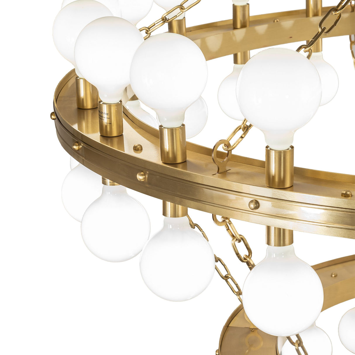 Albion chandelier close-up showing brushed brass finish and globe bulb mounts.