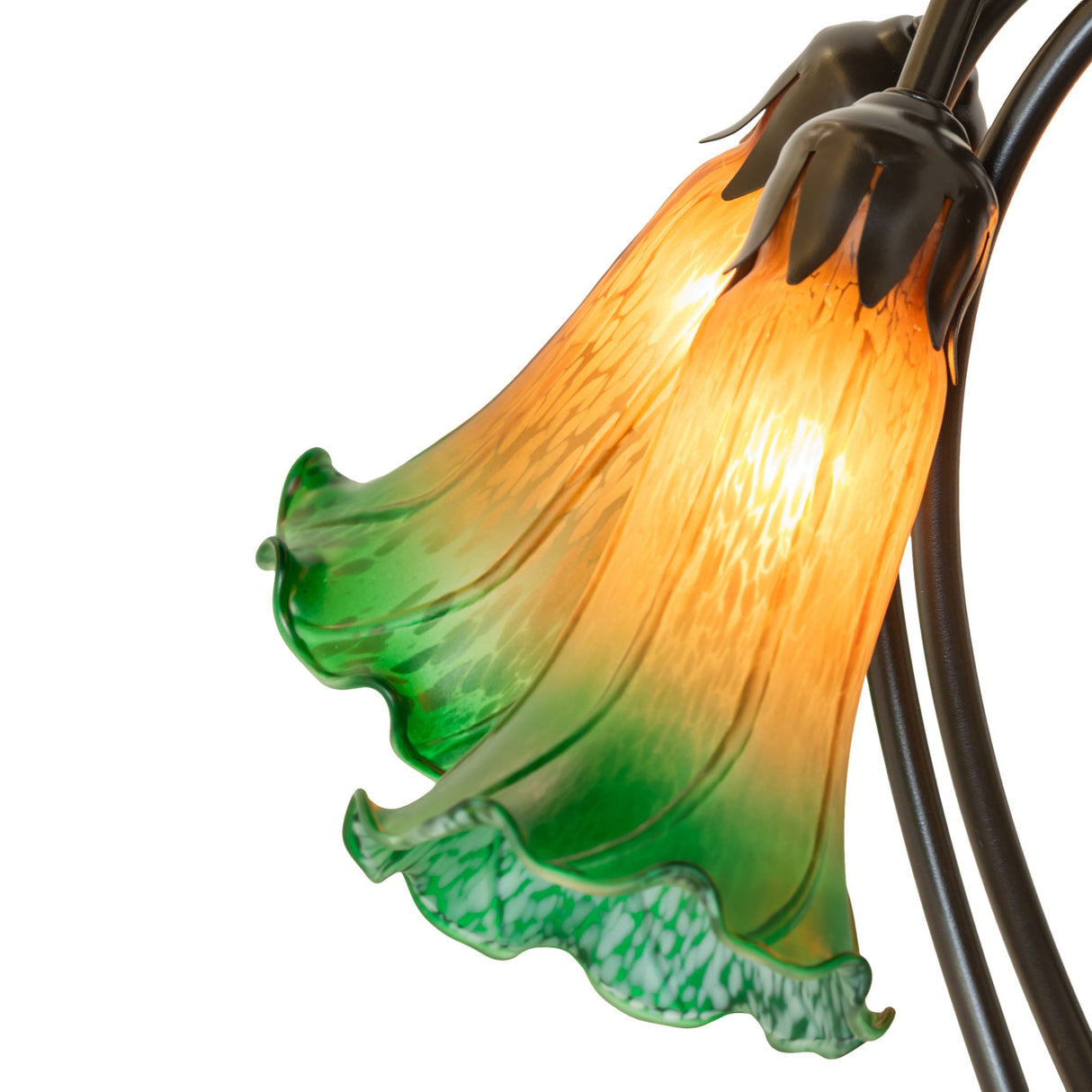 Detailed design of amber and green glass shades on tiffany lamp.