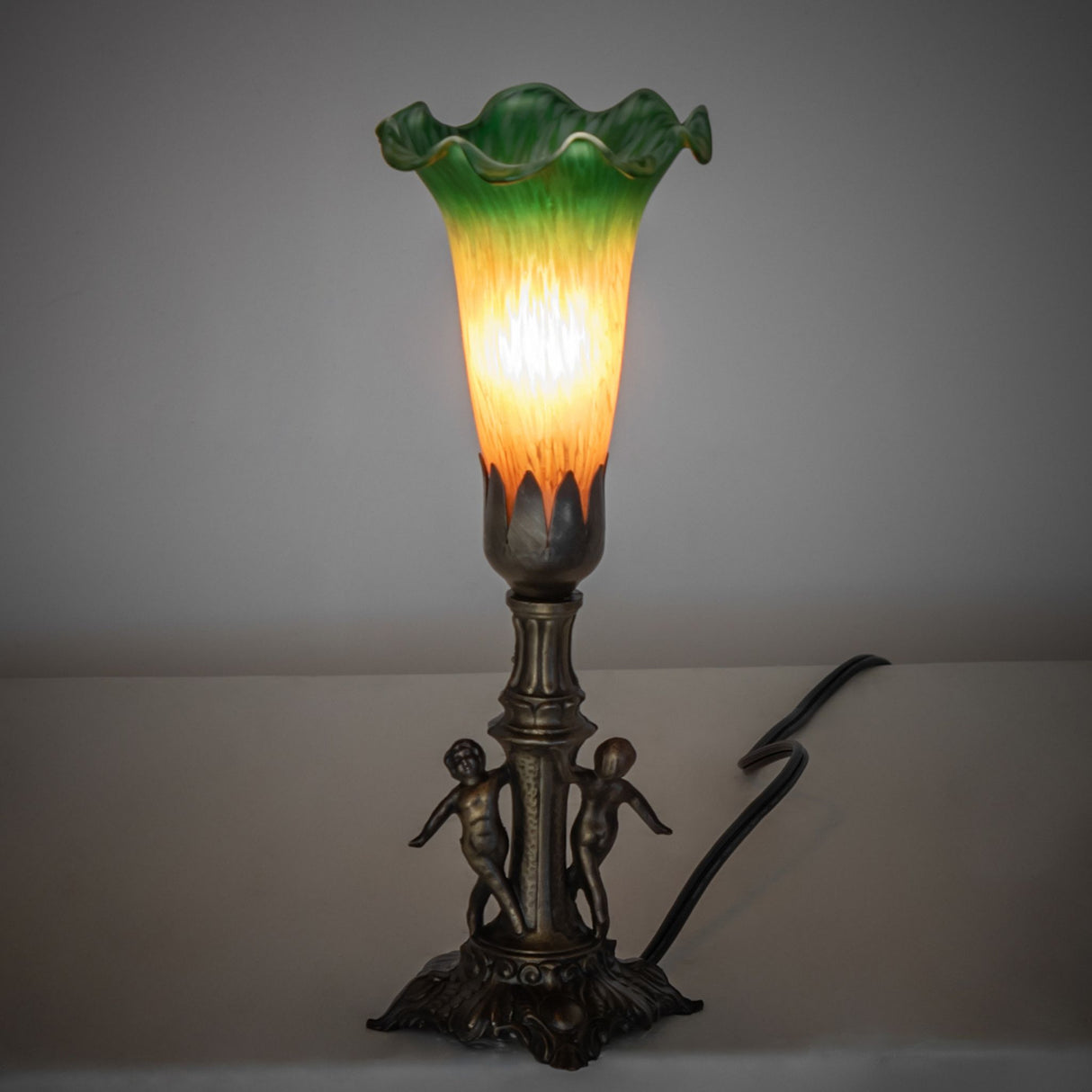 Ambient view of the Mini Lamp with visible cable, showcasing its softly glowing Favrile-style glass shade.
