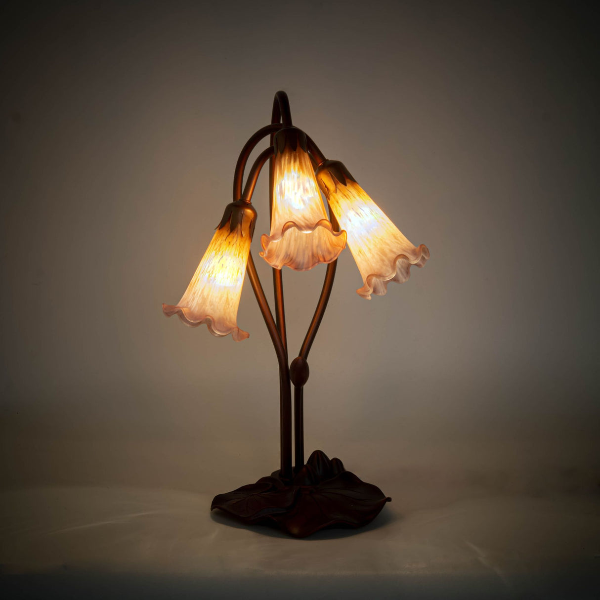 illuminated view of amber-purple pond lily table base showcasing warm and vibrant glow.