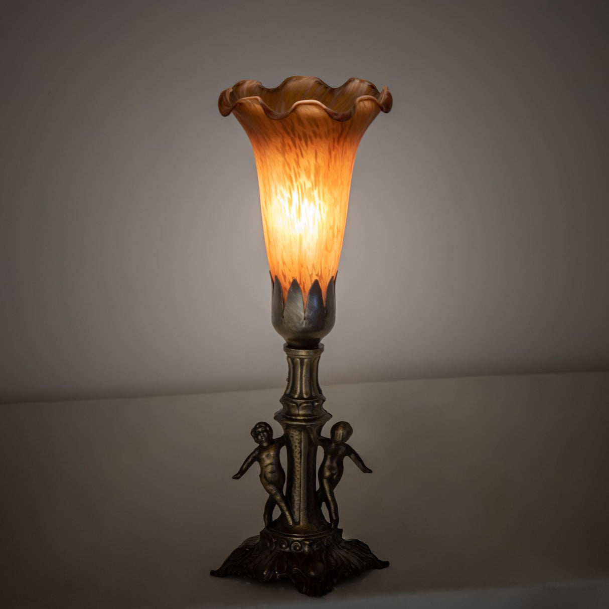 Warm ambient lighting from Amber Tiffany Pond Lily Maidens Mini Lamp.
