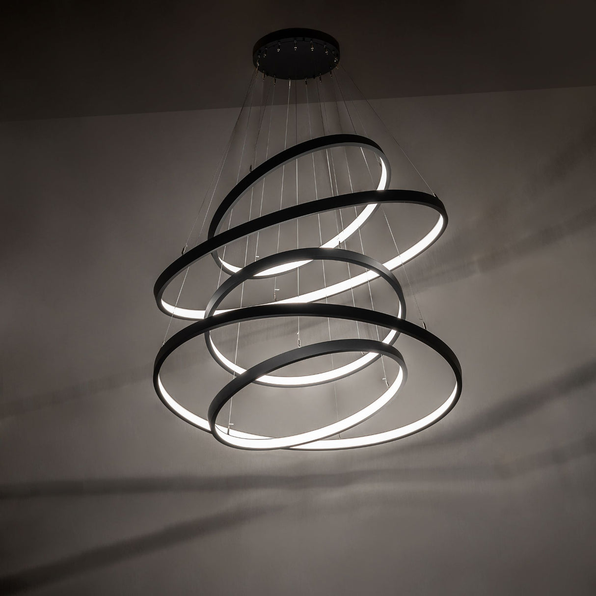 Anillo five-ring cascading chandelier creating dramatic ambient LED lighting effect.