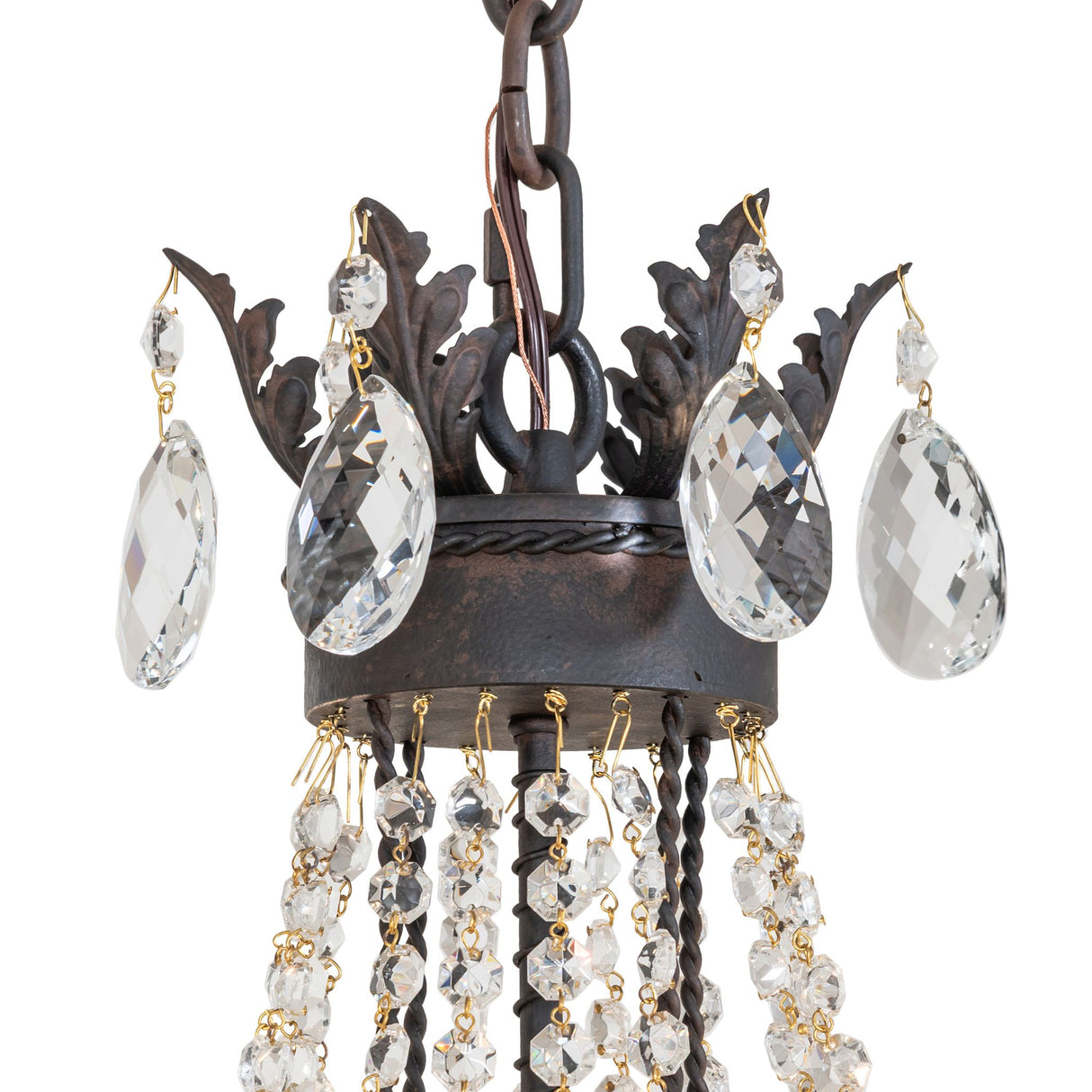 Close-up of chandelier arm with crystal teardrop accents.