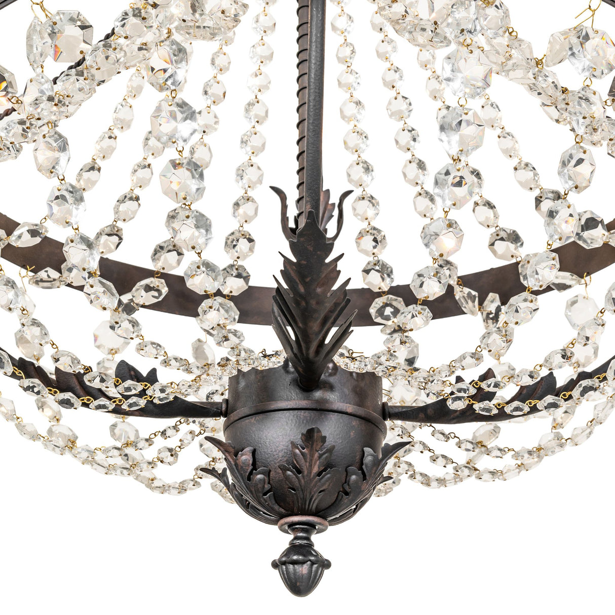 Lower detail of chandelier with crystal strands and decorative finial.