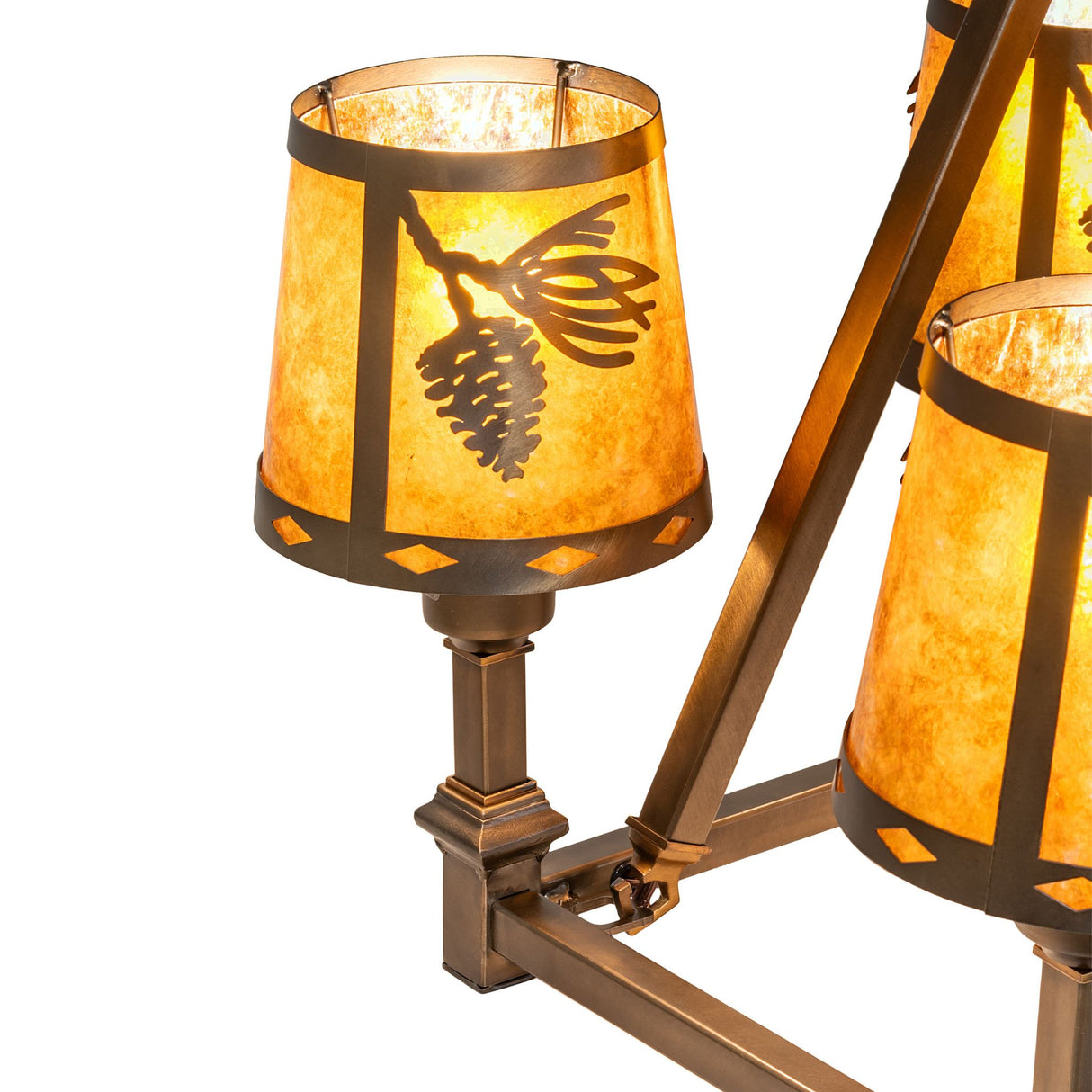 Close-up of amber mica shade with pinecone and needle design.