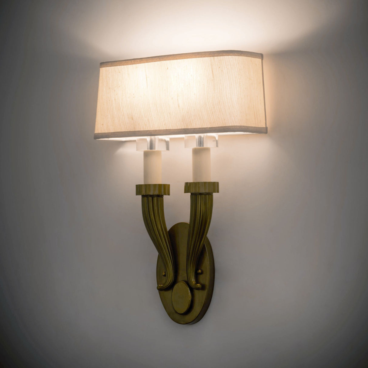 Bancroft 2 Light Wall Sconce illuminated, casting a warm glow.