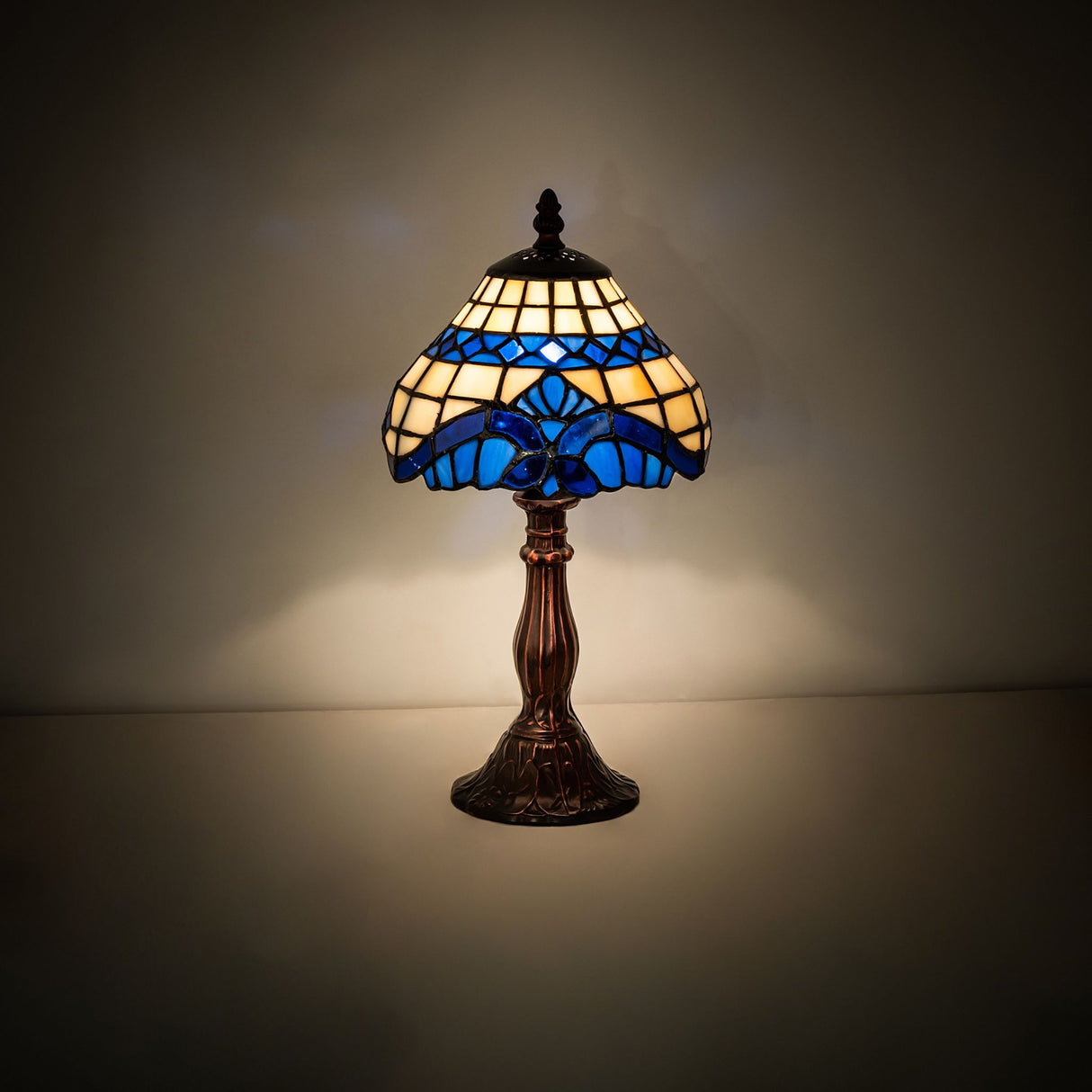 Baroque mini lamp with royal blue stained glass shade, lit view.