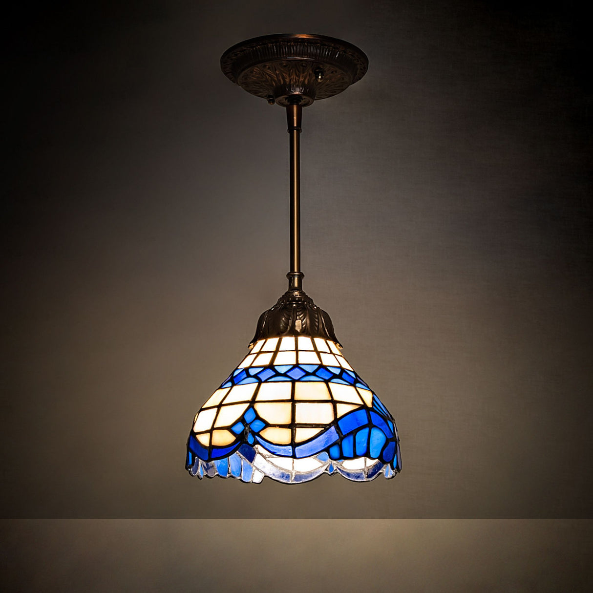 Baroque Mini Pendant illuminated, highlighting the vibrant glass details.