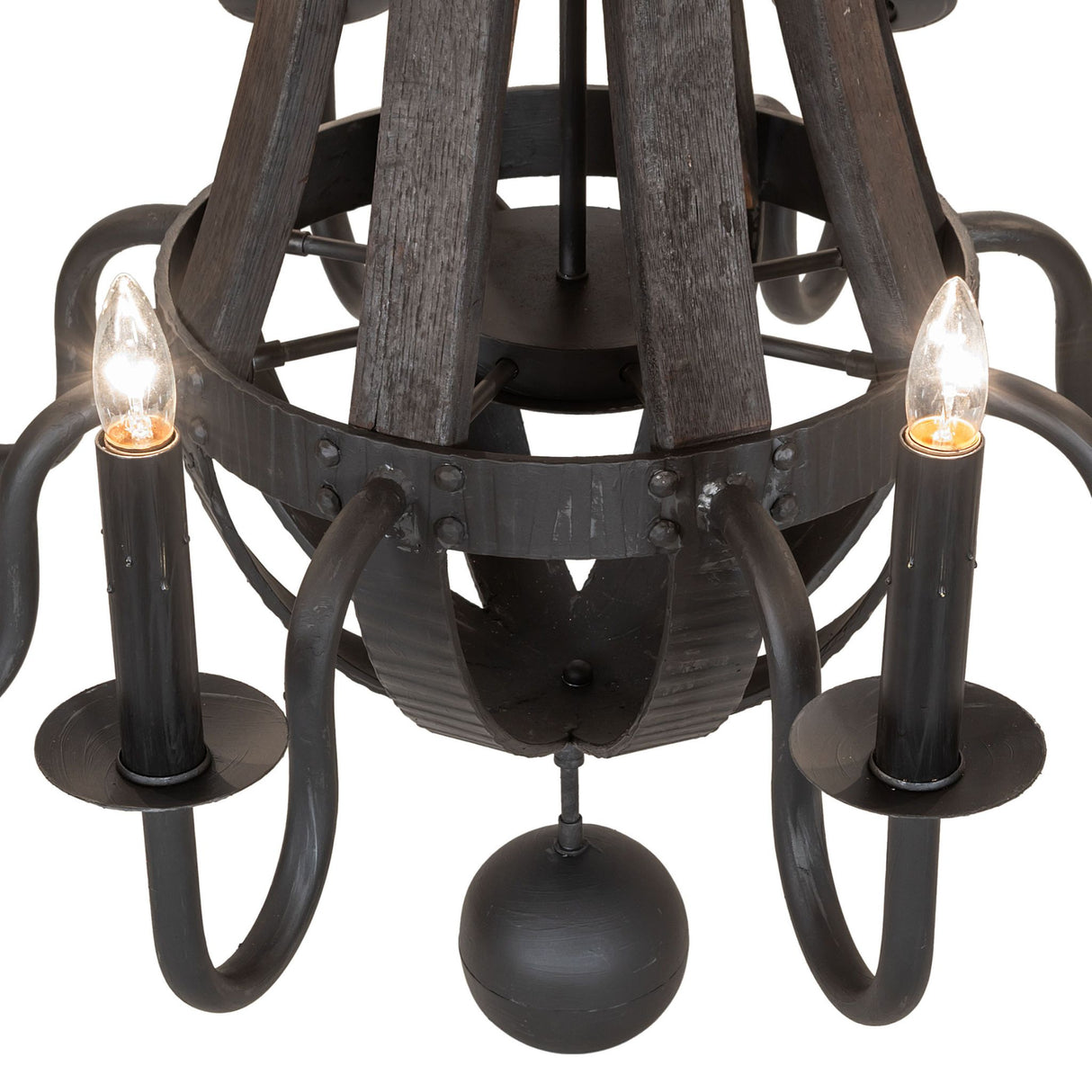 Close-up of faux candle bulb, bobeche, and hammered black metal arm with charred wood backdrop.