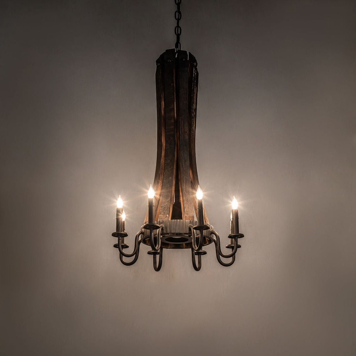 Rustic chandelier with candle-style lights illuminated and downlight turned off.