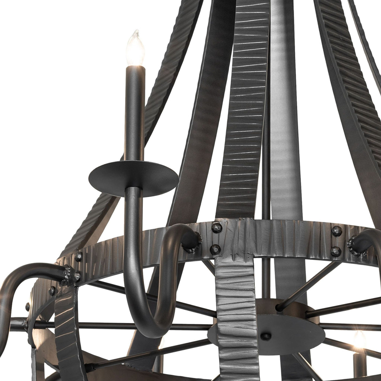 Close-up of candle-style light and curved wrought iron arm detail.