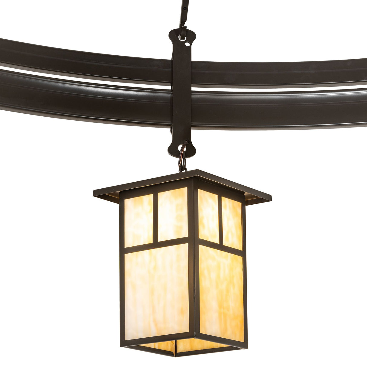 Close-up of beige art glass lantern shade on chandelier.