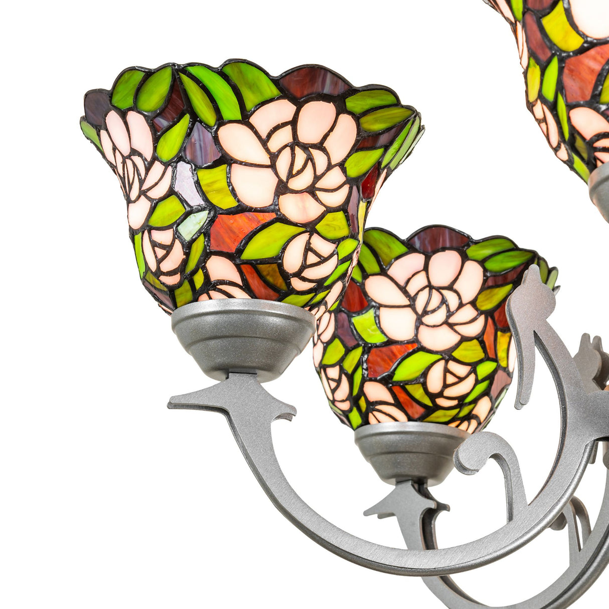 Close-up detail of stained glass shade featuring blush pink flowers and green leaf pattern.