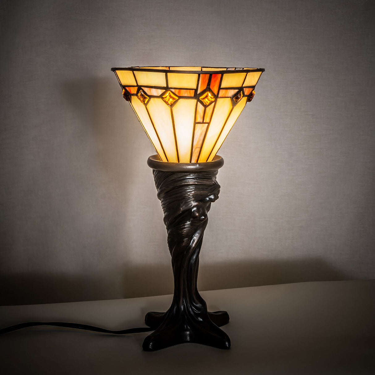 Illuminated view of the Belvidere Mini Lamp showcasing its warm Mahogany Bronze base.