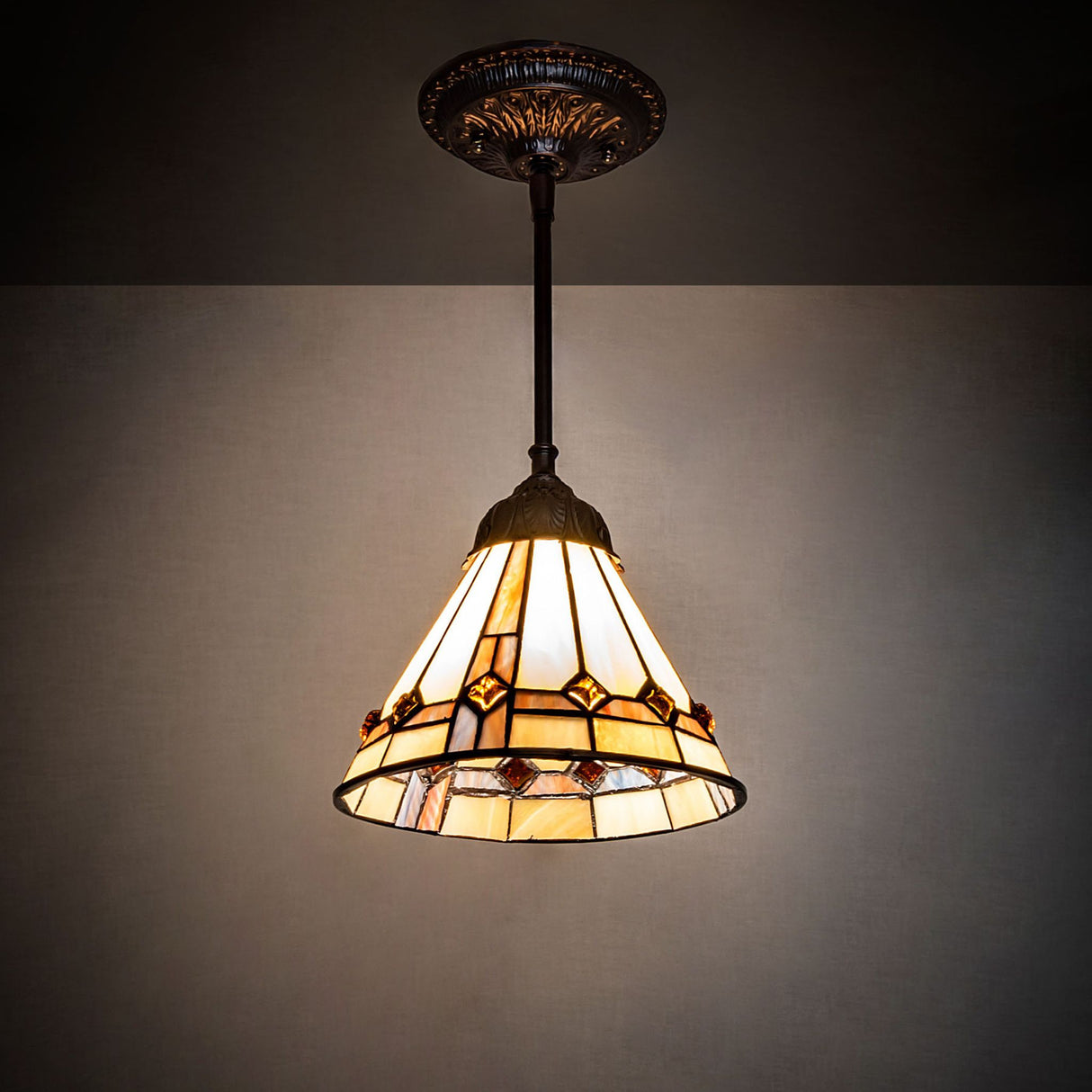 Belvidere Mini Pendant illuminated in a room setting with warm beige glow.