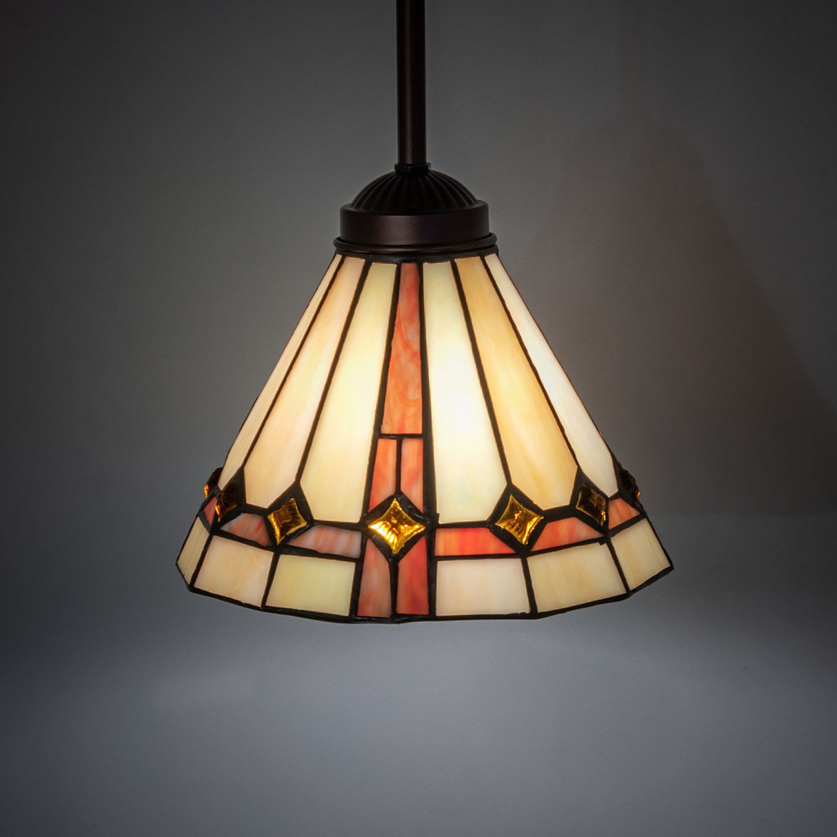 Illuminated Belvidere Mini Pendant displaying its vibrant stained glass patterns.