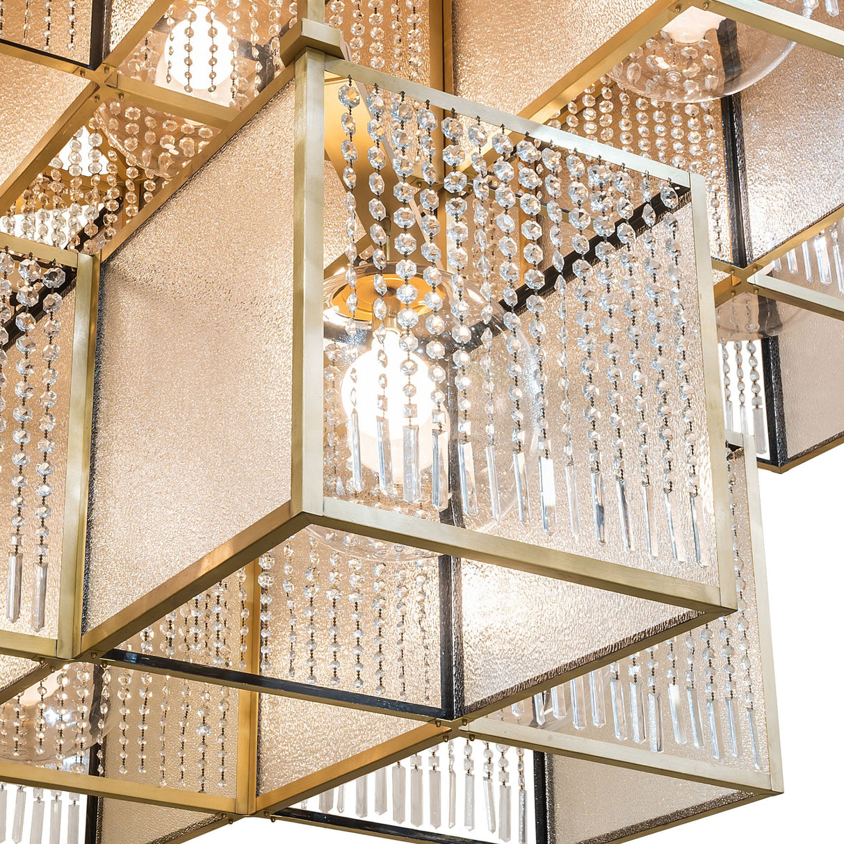 Closeup of cube frame with crystal bead strands and hanging prisms.