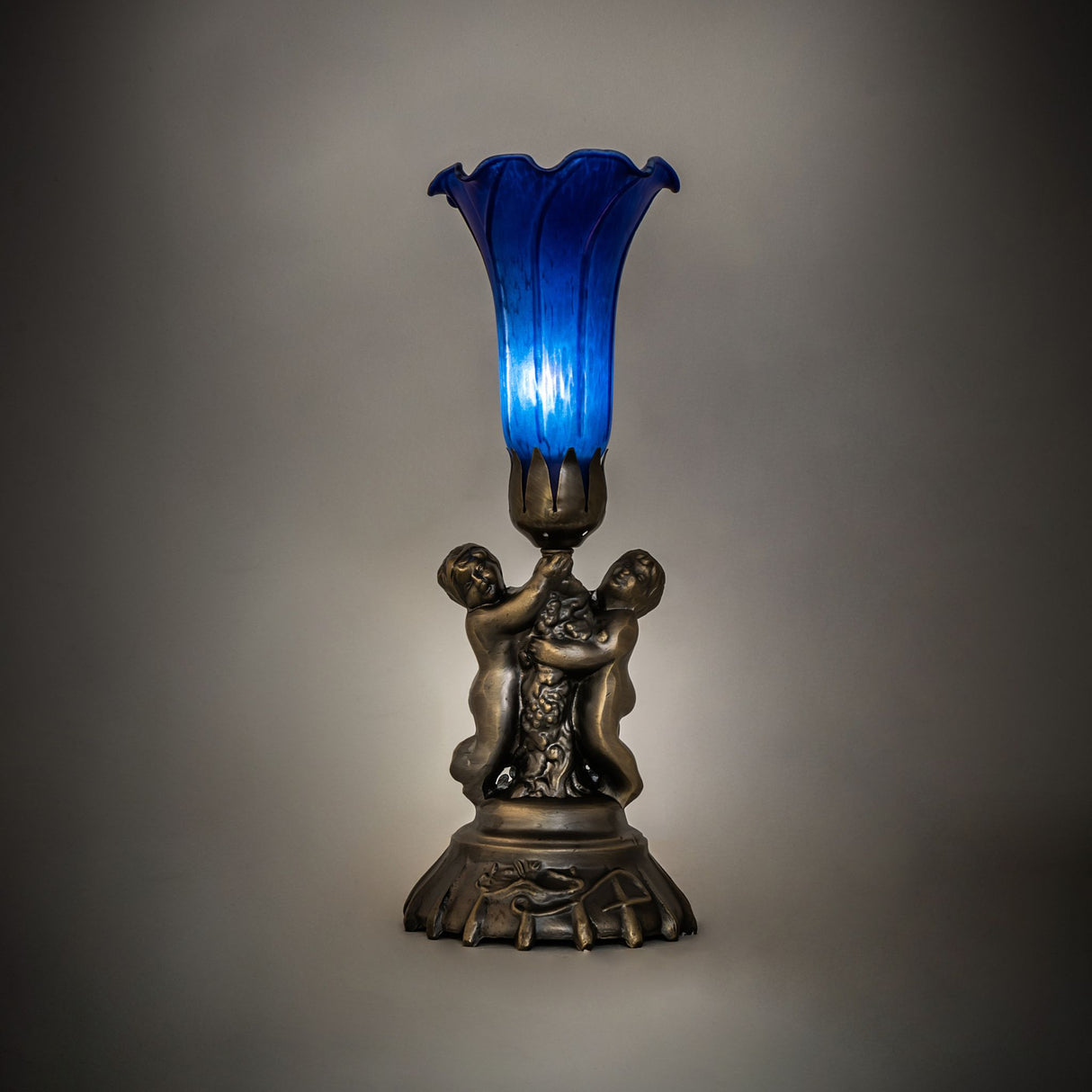 Blue Pond Lily Twin Cherub Accent Lamp ambient lighting view.