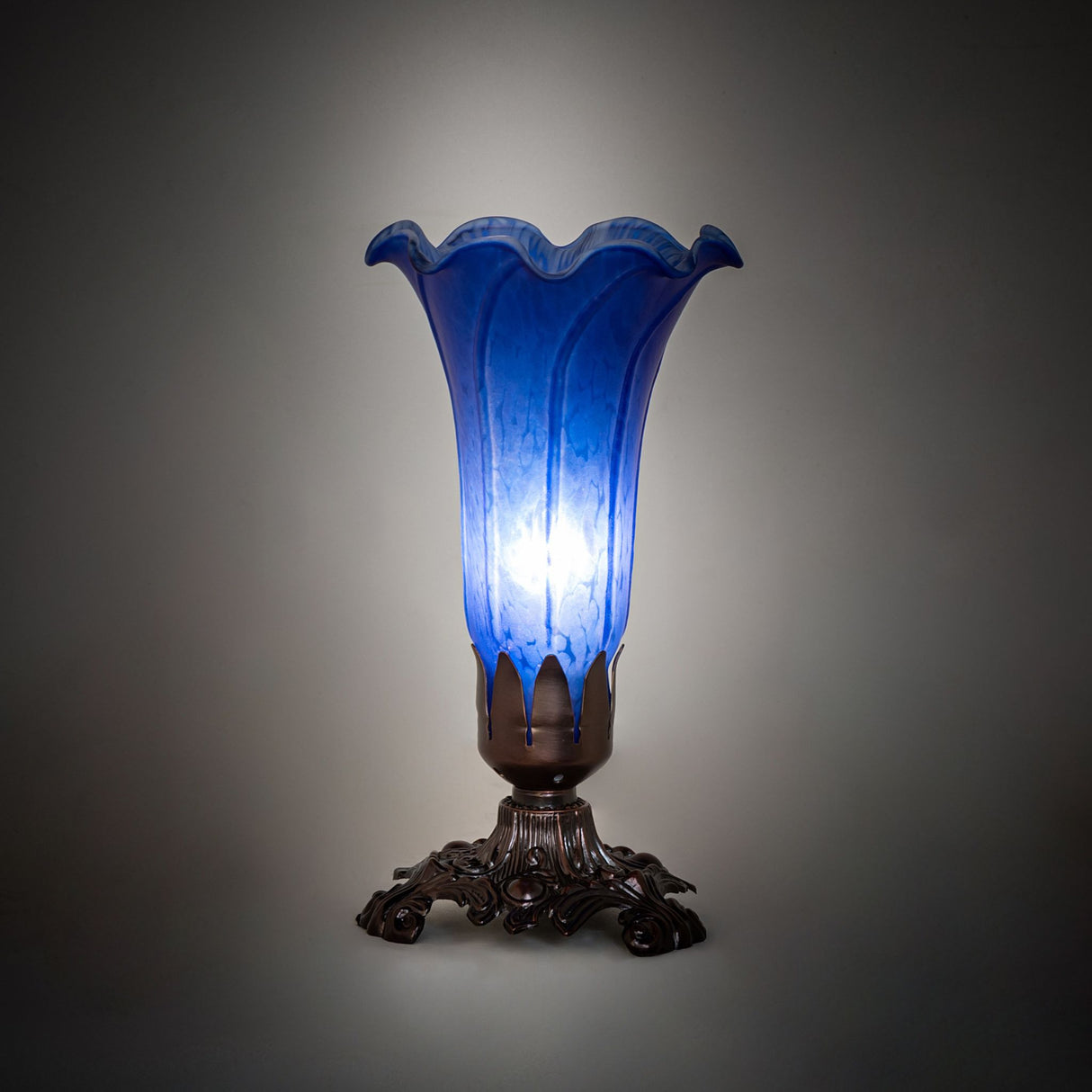 Illuminated Blue Tiffany Pond Lily Victorian Accent Lamp casting a soft ambient glow.