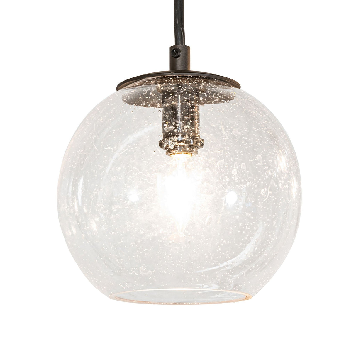 Closeup of clear glass orb pendant with Edison style bulb on Bola 12 light 2 tier chandelier.