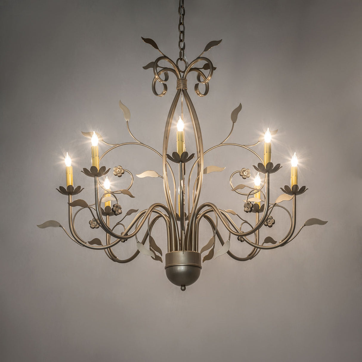 Ambient view of Bordeaux 8 light chandelier shown illuminated in an interior setting.