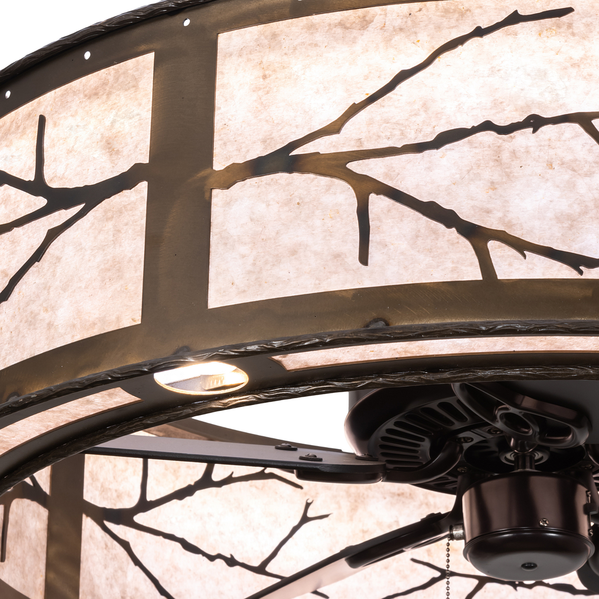 Close-up of metal branch detail and warm mica illumination.
