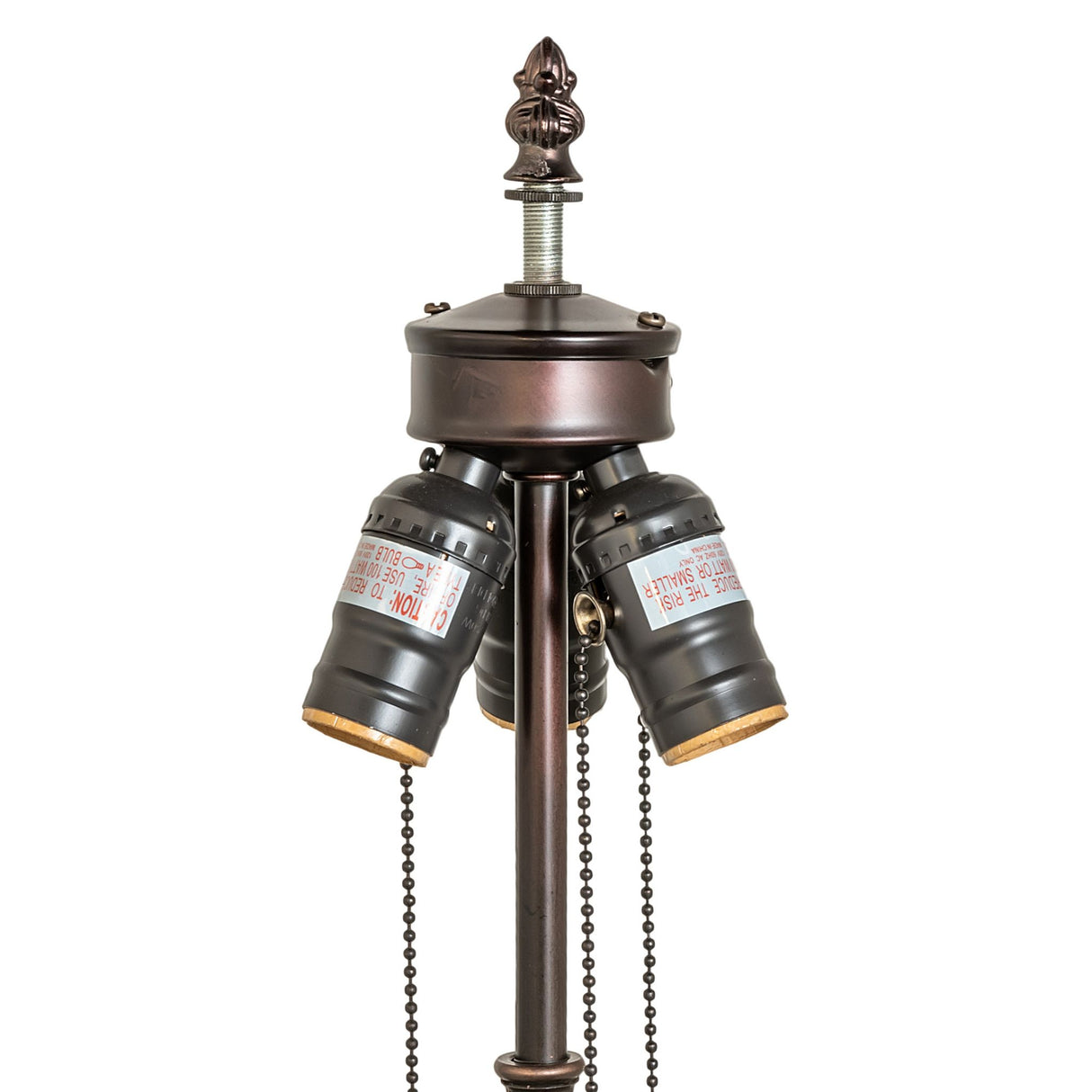 Close-up of table lamp's ornate bronze top.