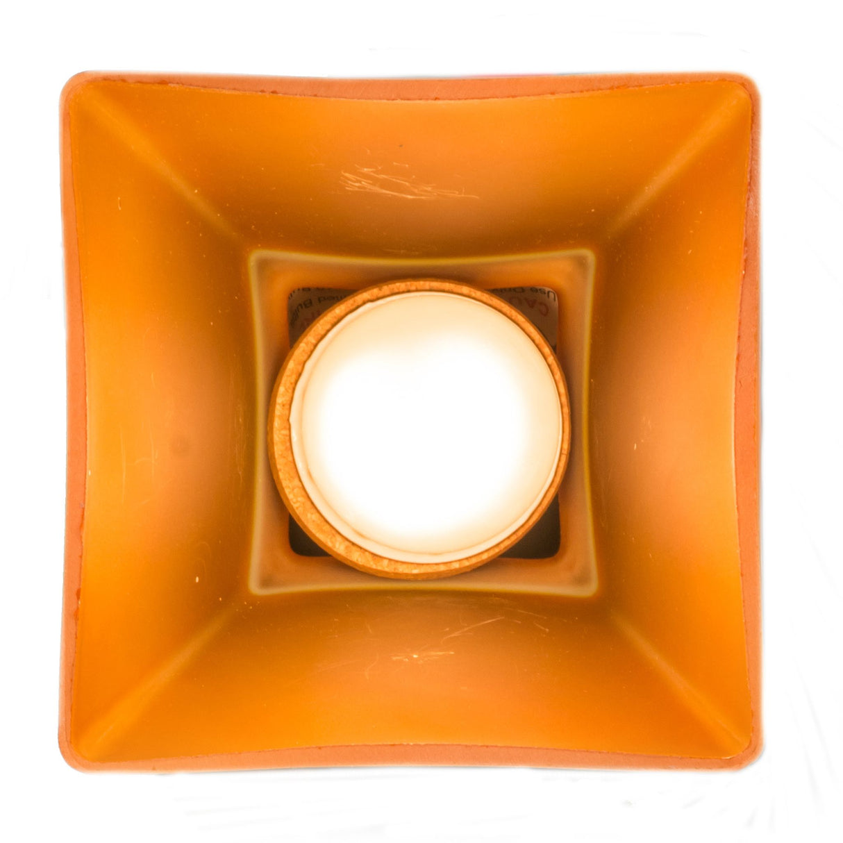 Bottom view of amber glass flushmount showing the bulb.