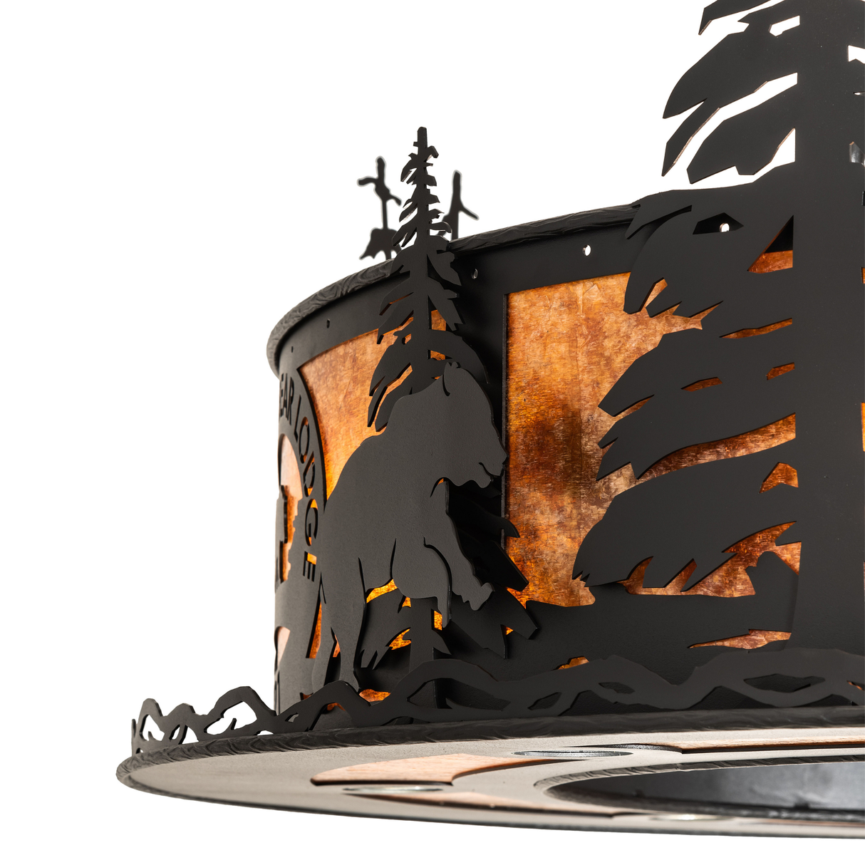 Close-up of bear and pine tree cutouts on amber mica Chasing Bear Lodge light.