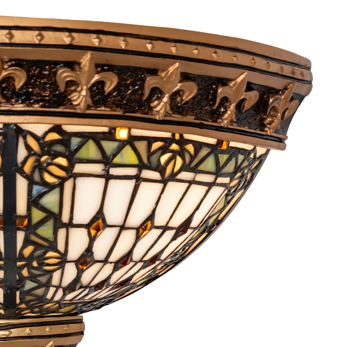Close-up of Fleur-de-lis wall sconce showcasing detailed stained glass and golden fleur-de-lis accents.