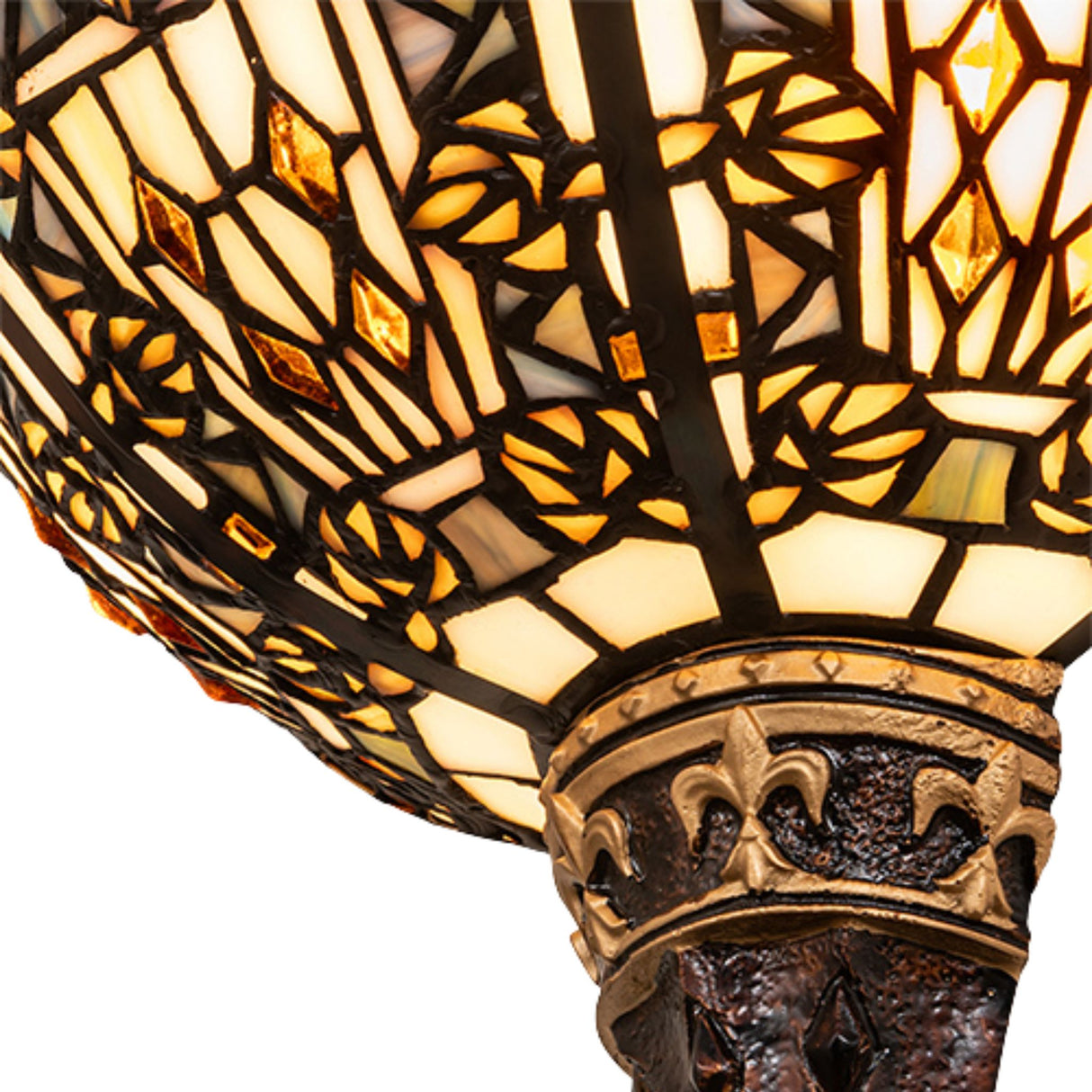 Close-up of intricate stained glass pattern on wall sconce.