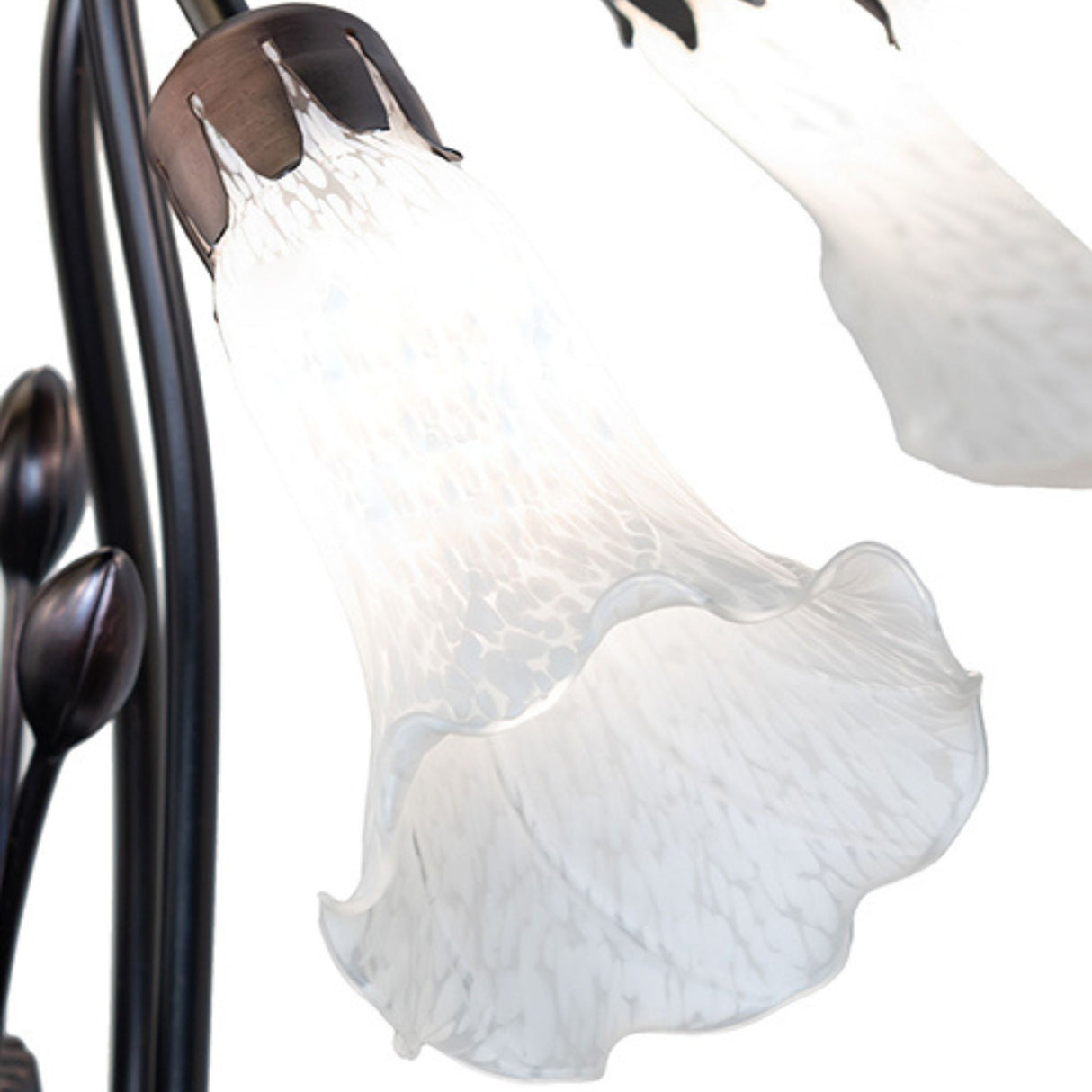 Close-up of white lily-shaped glass shade on Tiffany chandelier