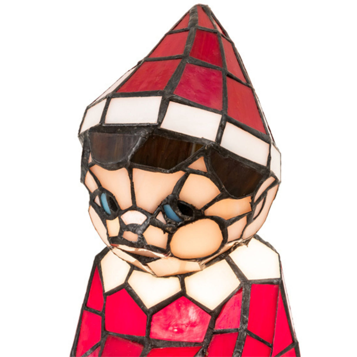 Close-up of stained glass elf lamp with red and white design.