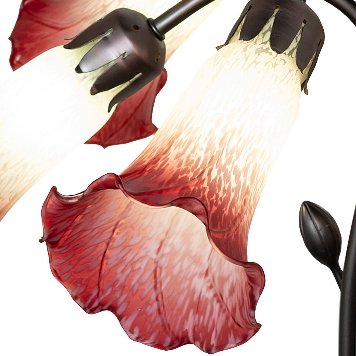 Close-up of cranberry and seafoam lily-shaped glass shade from a Tiffany-style chandelier.