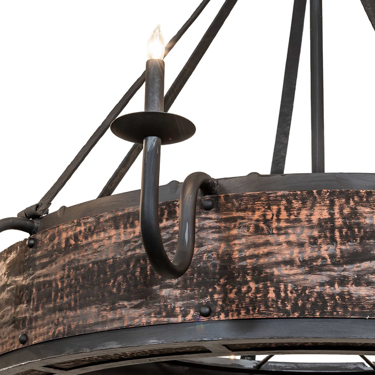 Closeup of wrought-iron candle arm and hammered copper band.