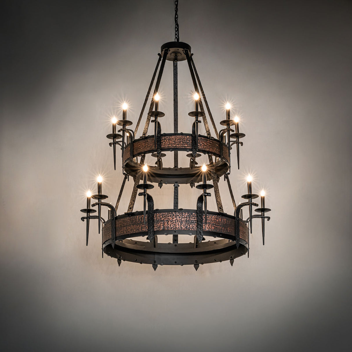 Costello chandelier illuminated in a dark room setting.