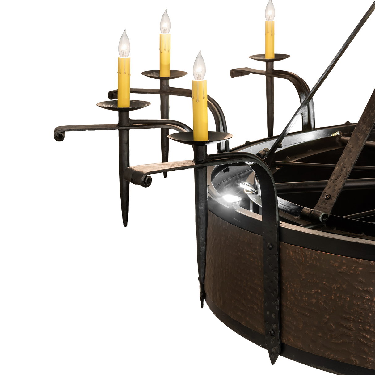 Close-up of clustered candle arms with glowing bulbs and hammered copper frame.