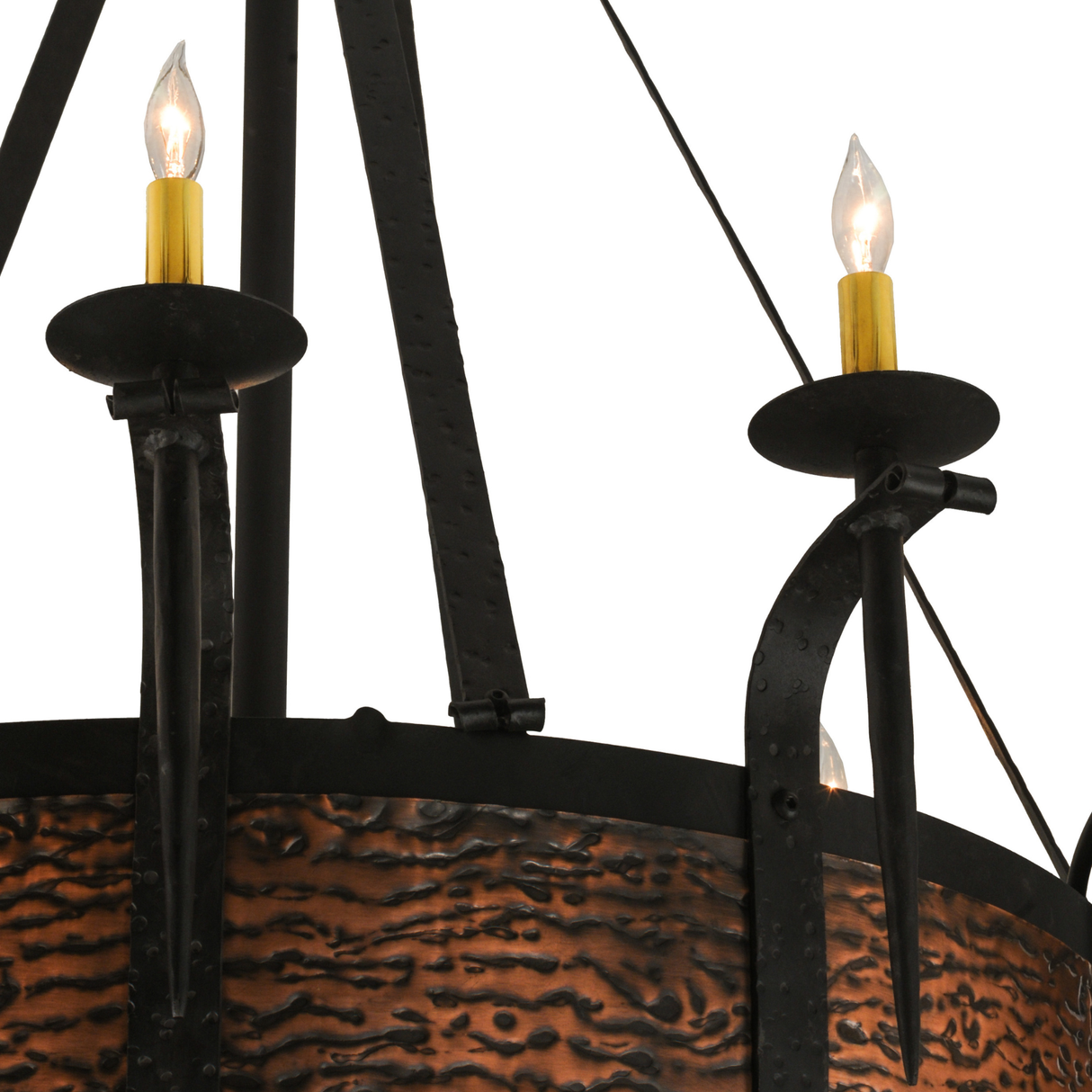 Closeup of hammered copper band and black wrought iron arms.