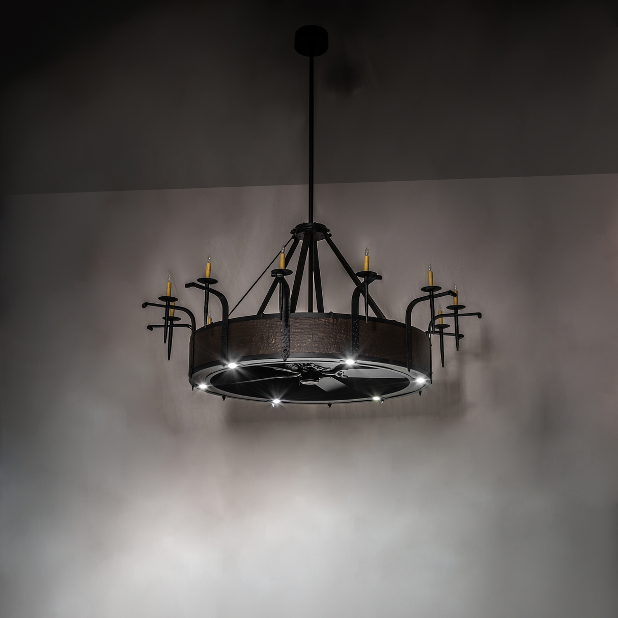 Softly illuminated chandelier view with rustic hammered metal detail.