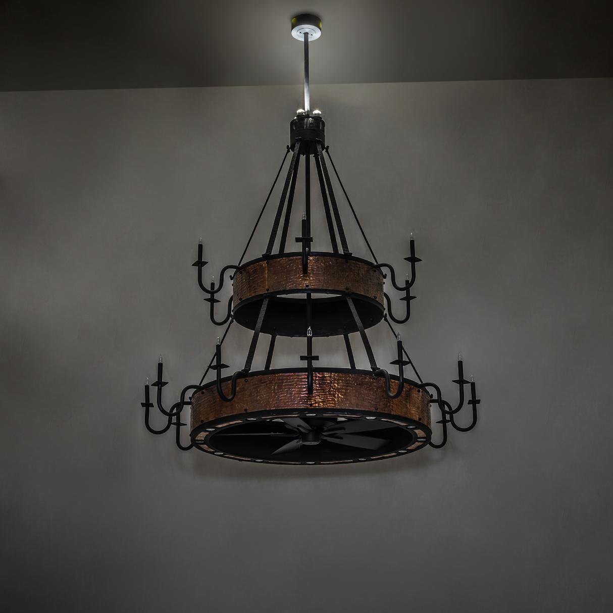 Dim-lit view of Costello chandelier fan showing rustic copper tones.