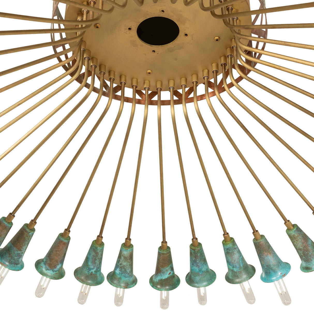 Close-up of Coyle chandelier hub with brushed brass finish and verdigris copper accents.
