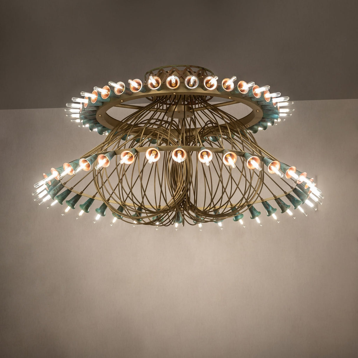 Ambient view of Coyle 72 light chandelier lit in room setting with warm LED glow.